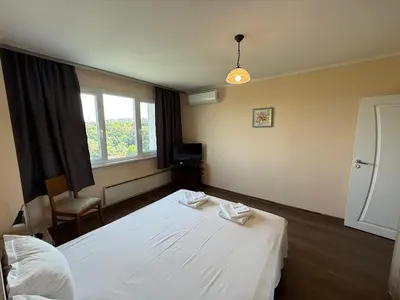 a hotel room with two beds and a window at Apartment Durvenitza in Sofia