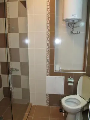 a bathroom with a toilet and a glass shower at Apartments Vasil Levski in Plovdiv