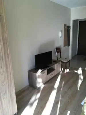 a living room with a flat screen tv on a cabinet at Park View Studios in Sandanski