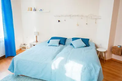a blue bed with blue pillows in a bedroom at Guest house Maison 21 in Plovdiv
