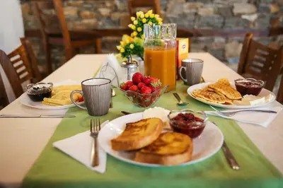 a table topped with plates of toast and fruit at House of Time in Ognyanovo