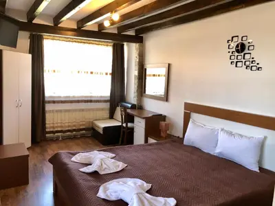 a bedroom with a bed with two towels on it at House of Time in Ognyanovo