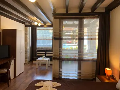 a room with a bed and a large window at House of Time in Ognyanovo