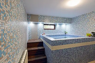 a bathroom with a tub with blue tiles at White House in Ognyanovo