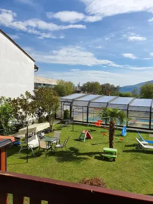 a garden with a playground and a greenhouse at White House in Ognyanovo