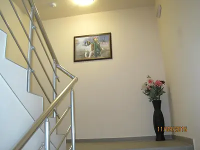 a stairway with a picture of a dog on the wall at Apart Hotel Rosen in Sofia