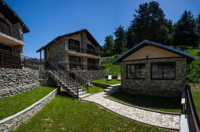 a building with a staircase leading up to it at Ваканционна къща ,,Родопски уют 