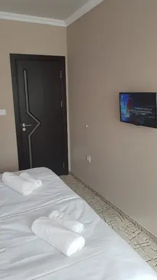 a bedroom with two white towels on a bed at Central Guest Rooms in Asenovgrad