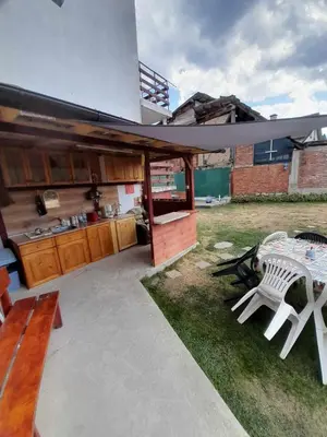 a patio with a kitchen and a table and chairs at Guest House Lorian in Madzhare
