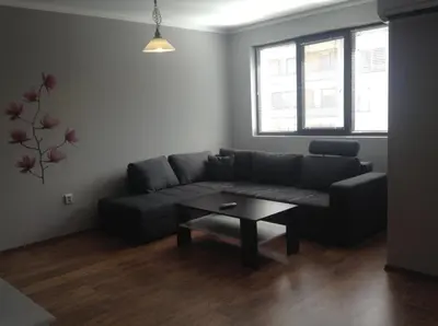a living room with a couch and a coffee table at Apartment Sredetz in Sofia