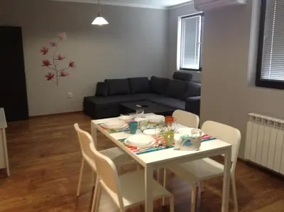 a living room with a table and a couch at Apartment Sredetz in Sofia