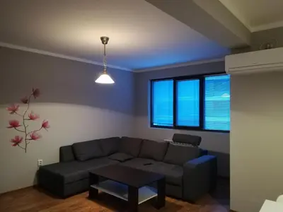 a living room with a couch and a table at Apartment Sredetz in Sofia
