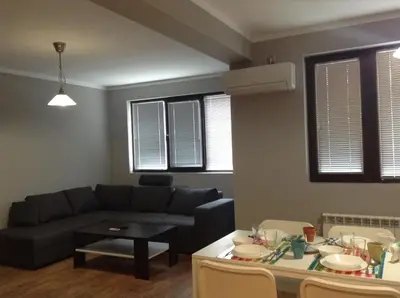 a living room with a couch and a table at Apartment Sredetz in Sofia