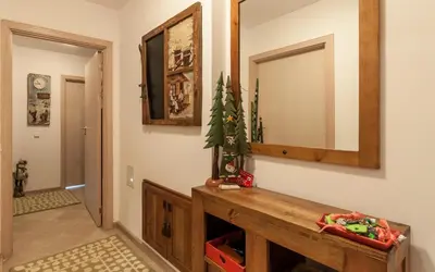 a living room with a mirror and a wooden table at Mountain Paradise 4 Apartments in Bansko