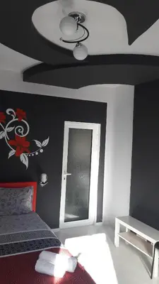 a bedroom with a bed and a black wall at Georgievi Guest House in Sapareva Banya