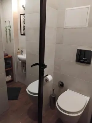 a bathroom with a toilet and a sink at Embassy Apartment in Sofia