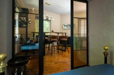 a dining room with a table and a mirror at ArtCity Villa - 3 Boutique Suits in Historic town in Plovdiv