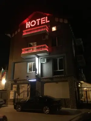 a car parked in front of a hotel at night at Hotel Chamishki in Blagoevgrad