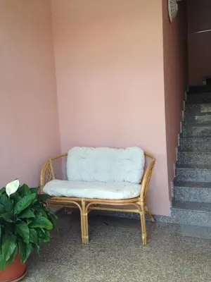 a bench with a white pillow on it next to a staircase at Center Guest House in Sapareva Banya