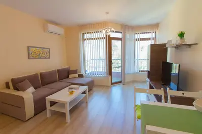 a living room with a couch and a table at Domus Apartments Old Town with Garage in Plovdiv