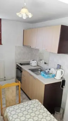 a kitchen with a sink and a counter top at Tsvetkovi Guest House in Dobrinishte