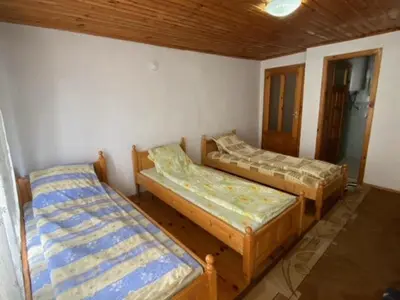 a room with three beds in a room at Tsvetkovi Guest House in Dobrinishte