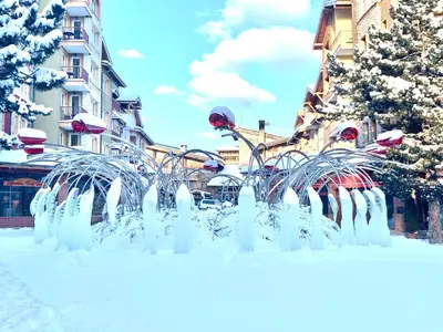 a fountain in the snow in a city at Entire Private Apartment in Pirin Golf & Country Club in Bansko