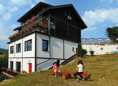 two children playing in front of a house at Villa AdiArt in Arda