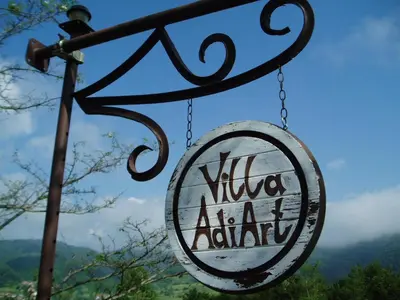 a sign that reads viva azaaria hanging from a pole at Villa AdiArt in Arda