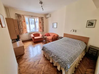a bedroom with a bed and a couch and a chair at Asen 36 Apartment in Sofia