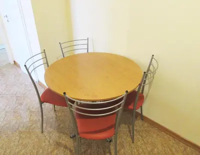 a wooden table and chairs in a room at Asen 36 Apartment in Sofia