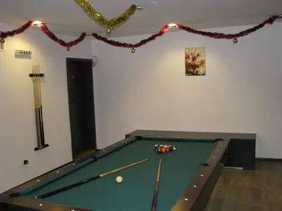 a room with a pool table with cue balls at Park Hotel Eagle Stone in Koprivshtitsa