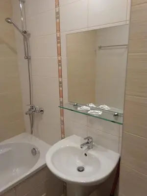 a bathroom with a sink and a tub and a mirror at Studio in Borovets Gardens Complex in Borovets