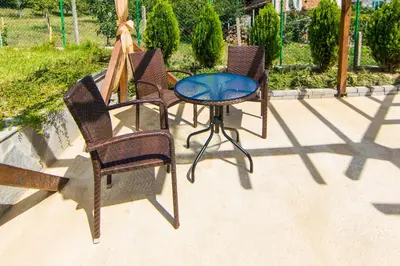 two chairs and a table on a patio at Guest House Ognyanovo in Ognyanovo