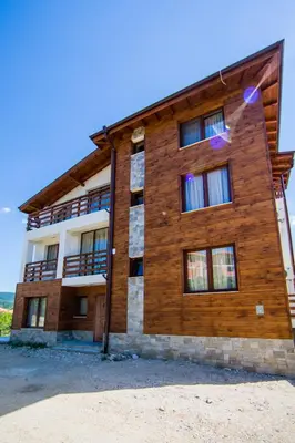 a wooden building with windows on the side of it at Guest House Ognyanovo in Ognyanovo