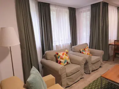 a living room with two chairs and a couch at Villa Park Apartment nr 216 in Borovets