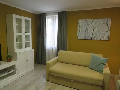 a living room with a couch and a window at Villa Park Apartment nr 216 in Borovets