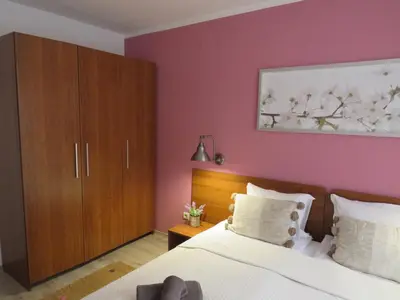a bedroom with purple walls and a bed and a wooden cabinet at Villa Park Apartment nr 216 in Borovets