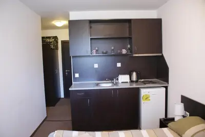 a small kitchen with a sink and a refrigerator at Mountain Top Mina in Bansko