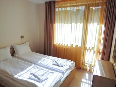 a bedroom with a bed with towels on it at Rivendell Apartments Borovets Gardens complex in Borovets