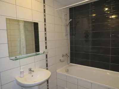 a bathroom with a sink and a tub and a mirror at Rivendell Apartments Borovets Gardens complex in Borovets