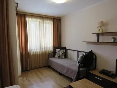 a small bedroom with a bed and a window at Rivendell Apartments Borovets Gardens complex in Borovets