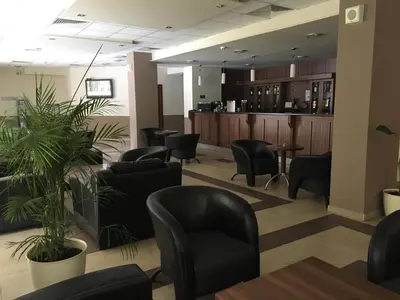 a waiting room with chairs and a bar at Rivendell Apartments Borovets Gardens complex in Borovets