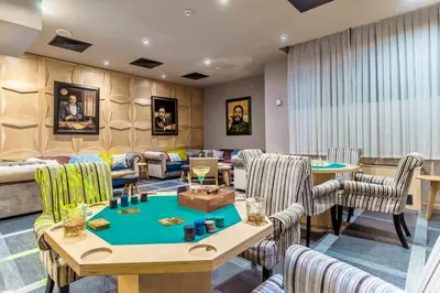 a waiting room with a table and chairs at Hotel Arte SPA & Park in Velingrad