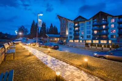 a row of cars parked in a parking lot with lights at Hotel Arte SPA & Park in Velingrad