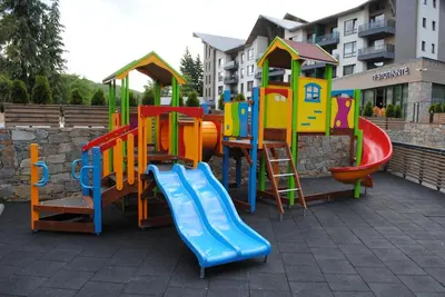 a playground with a slide and a slide at Hotel Arte SPA & Park in Velingrad