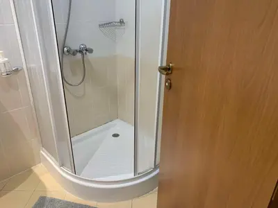 a shower with a glass door in a bathroom at Villa Park Studio Apartment nr 409 in Borovets