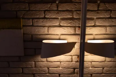 a pair of lights in front of a brick wall at Lozenets Apartment in Sofia