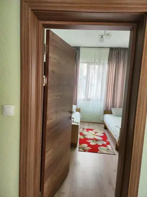a door to a room with a bed and a bedroom at Apartment Lachevi in Sandanski