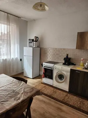 a kitchen with a washing machine and a refrigerator at Apartment Lachevi in Sandanski